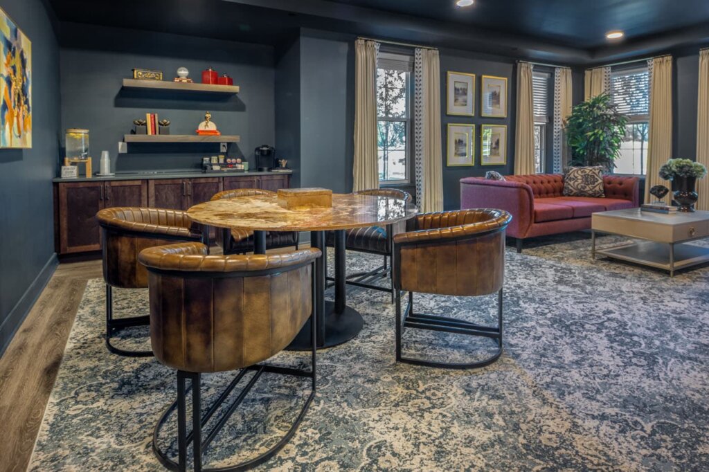 Coffee lounge at Traditions of Westfield with leather chairs, round table, and cozy seating nook